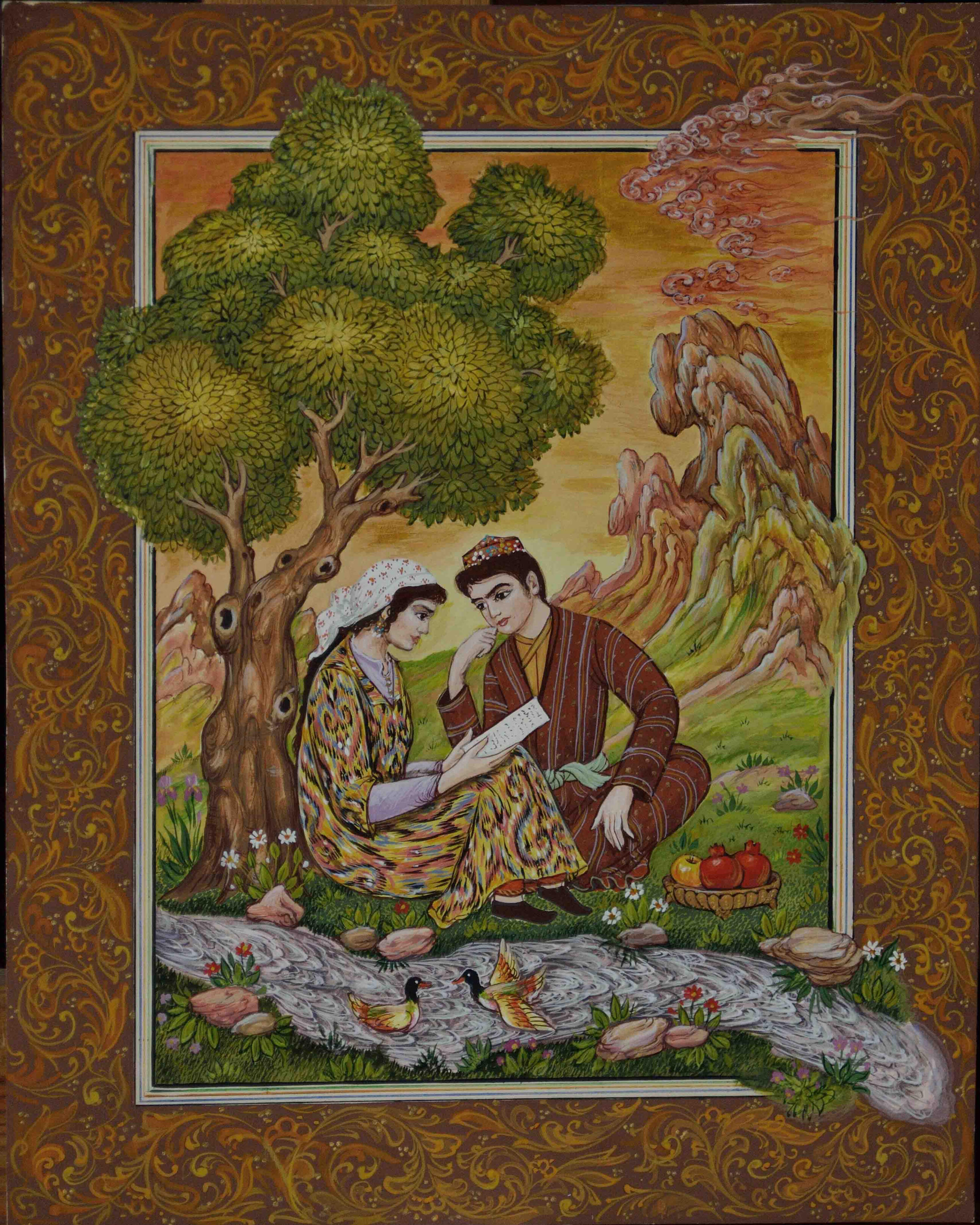 Olim Kamolzoda is the Honoured Artist of the Republic of Tajikistan. Photo of Olim Kamolzoda sitting at the desk in his workshop. He is the Honoured Artist of the Republic of Tajikistan, a Member of the Union of Artists of the Republic of Tajikistan, and a Specialist of the Miniature Art. Studying the specifics of the work