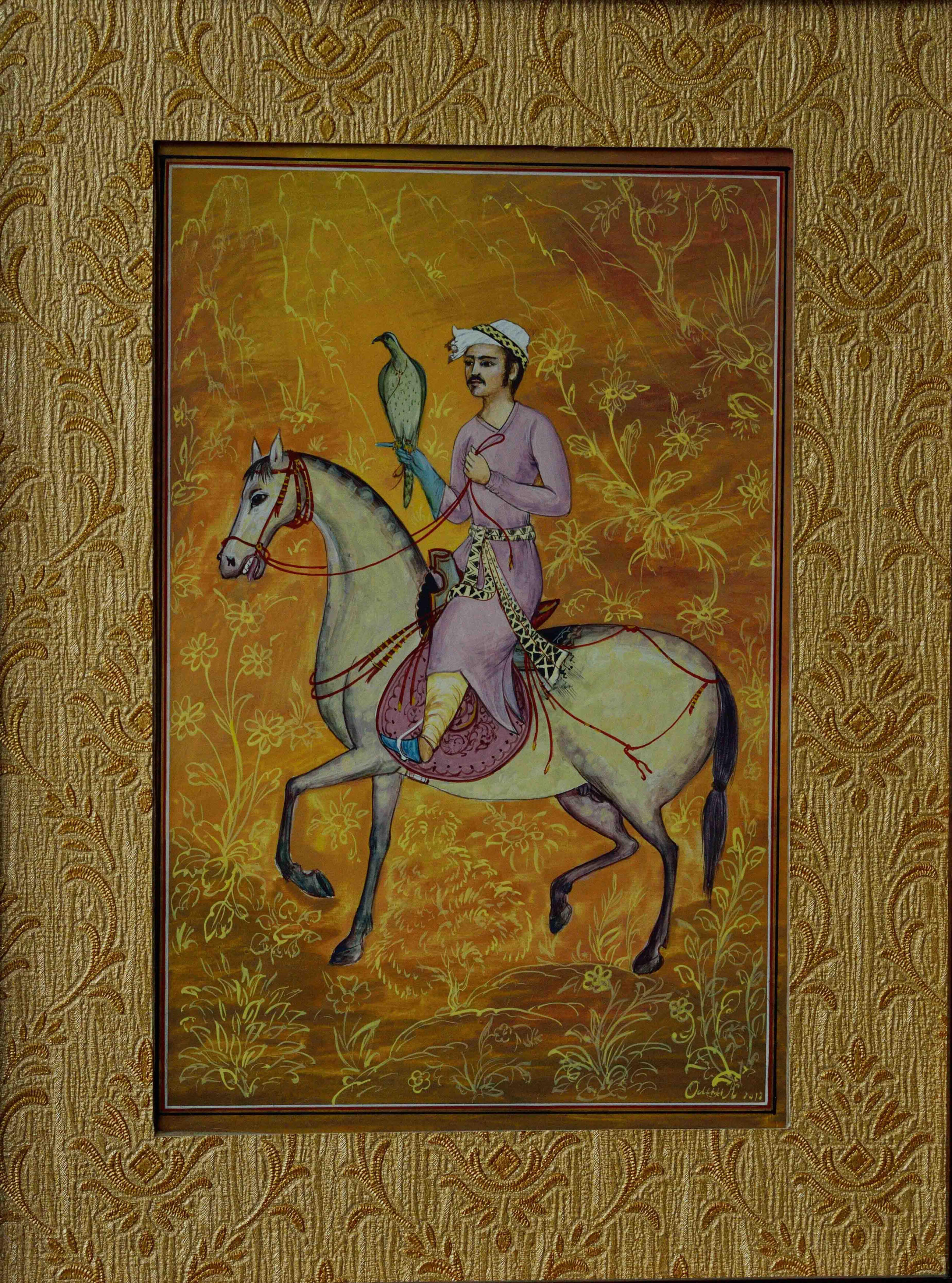 Olim Kamolzoda is the Honoured Artist of the Republic of Tajikistan. Photo of Olim Kamolzoda sitting at the desk in his workshop. He is the Honoured Artist of the Republic of Tajikistan, a Member of the Union of Artists of the Republic of Tajikistan, and a Specialist of the Miniature Art. Studying the specifics of the work